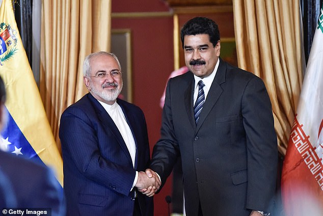 Venezuelan President Nicolás Maduro (right) and Iranian Foreign Minister Mohammad Javad Zarif (left) shake hands in Venezuela in August.