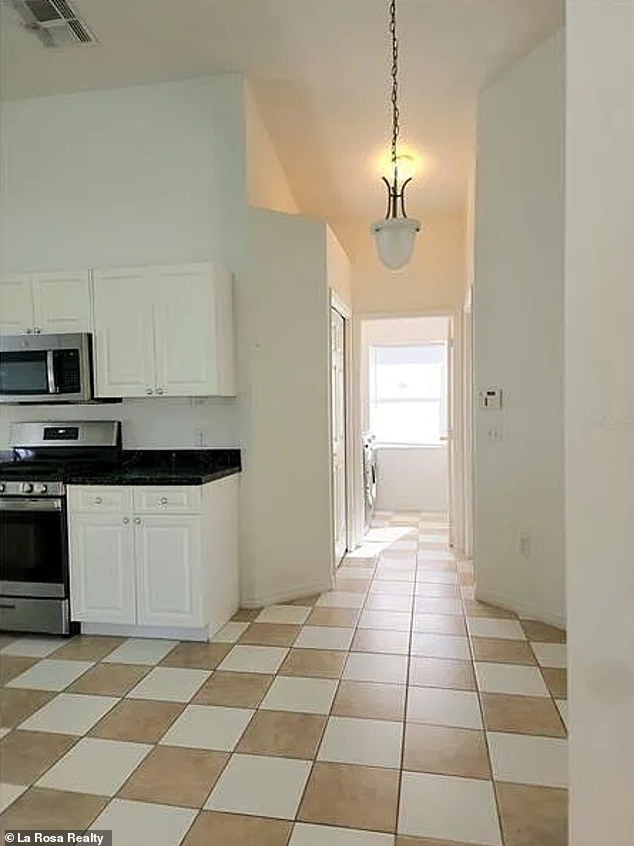 There are also sleek white cabinets and black marble countertops.