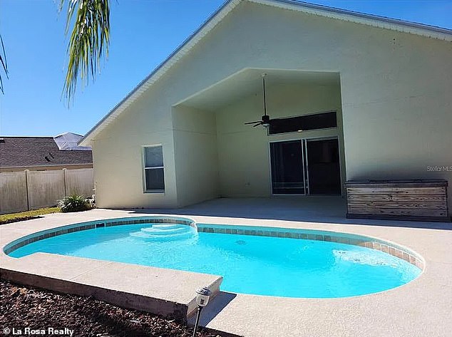 Fun in the sun - the backyard has a large pool surrounded by towering palm trees