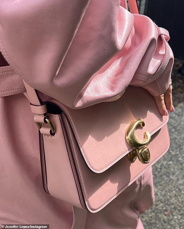 It's not a coincidence!  Lopez also wore a matching pink trench coat and Coach bag, considering she's been a global brand ambassador for the New York fashion house since 2019.