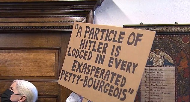 A protester holding a sign outside the Wintemute talk at McGill University on Tuesday.