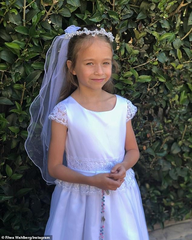 Grace Through the Years: Seemingly getting older, Grace looks cute in her white dress and matching headdress.