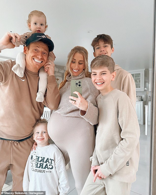 Elated: Pregnant Stacey couldn't contain her smile in a sweet family photo on Monday