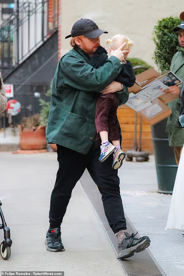 Laid back: Rupert cut a casual figure as he bundled up in a dark green jacket as he walked past Georgia, who was pushing the empty stroller