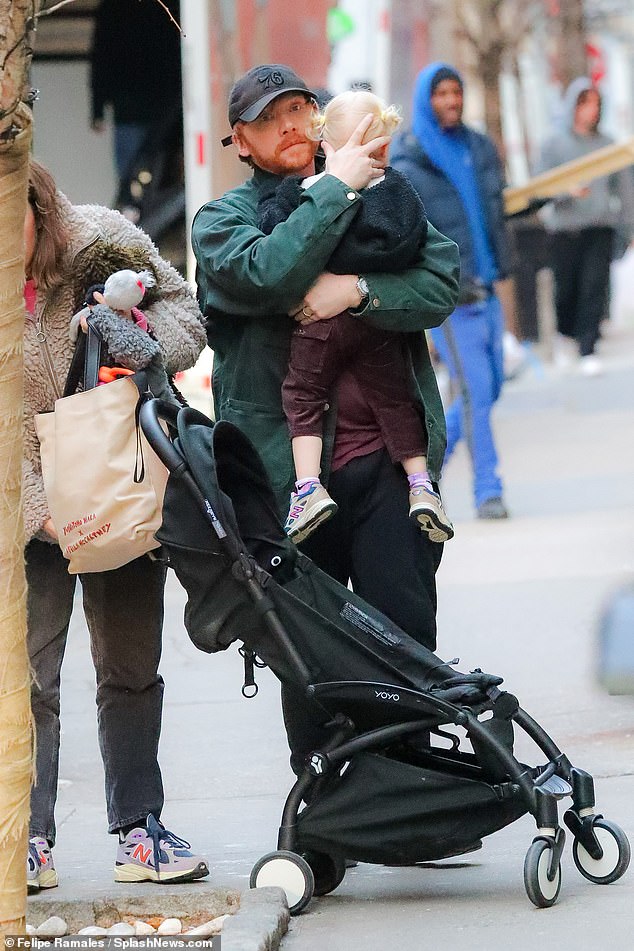 Low key: Their daughter had her blonde hair tied up in adorable pigtails as Georgia carried her stuffed toy as they stepped out