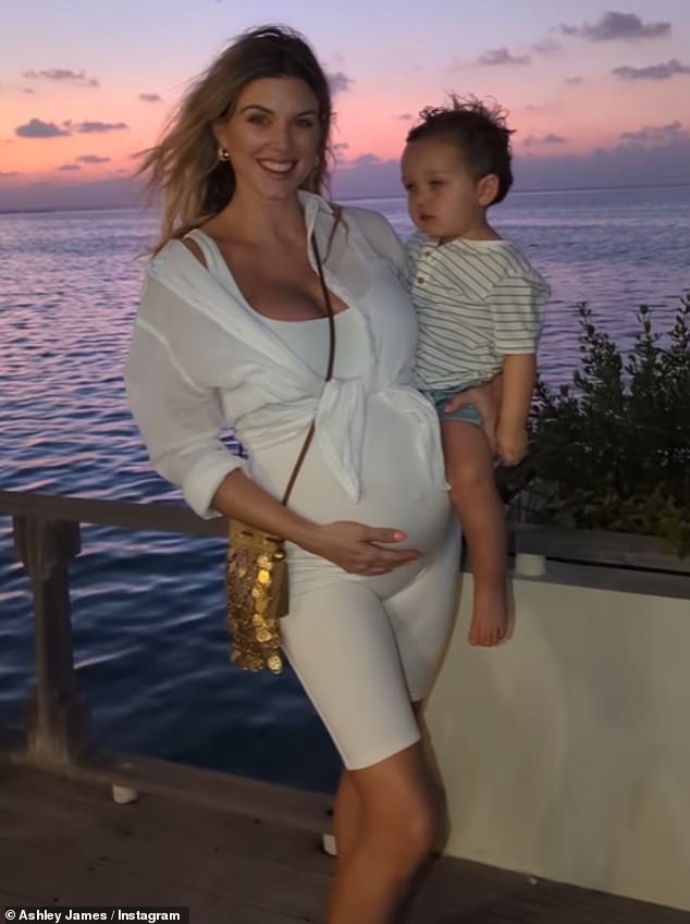 Wonderful: The Maldives is never short of gorgeous sunsets, with a third image showing Ashley holding Alfie with a beaming smile on her face and wearing an all-white outfit