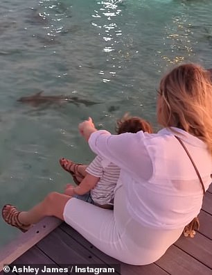 Check it out!  That same night, the mother-of-one sat on a walkway platform to watch the sharks and rays swimming below.