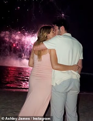 Love is in the air: Ashley and Tom shared a New Years kiss in front of the fireworks display