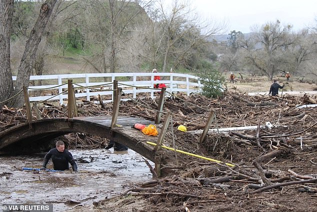 Pictured: A rescue team searches for 5-year-old Kyle Doan, who was washed away by floodwaters, in San Luis Obispo County, California, U.S., on January 11, 2023.