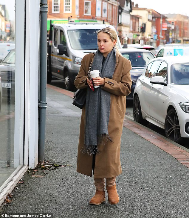 Outing: Molly-Mae covered her tummy in a gray coat and had a hot drink before the date