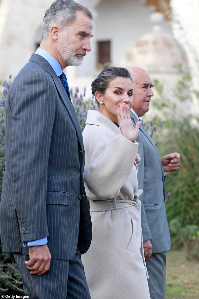 Letizia's hair was styled into a sleek updo, with her signature streak of gray gleaming in the light.