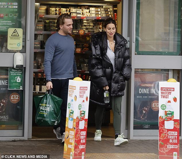 There they are: Walking with her partner, Ferne wore a gray workout top with khaki leggings and Nike Dunk sneakers, and carried a bottle of water in her hand.