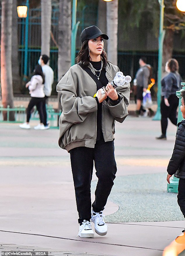 Laid back: The 41-year-old Honest company mogul donned an oversized baseball cap and bomber jacket as she arrived at the happiest place on Earth on Monday