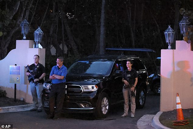 Armed Secret Service agents stand outside the driveway of former President Donald Trump's Mar-a-Lago estate, Monday, Aug. 8, 2022, in Palm Beach, Florida, as the FBI searched part of his home for files. classifieds taken from the White House.