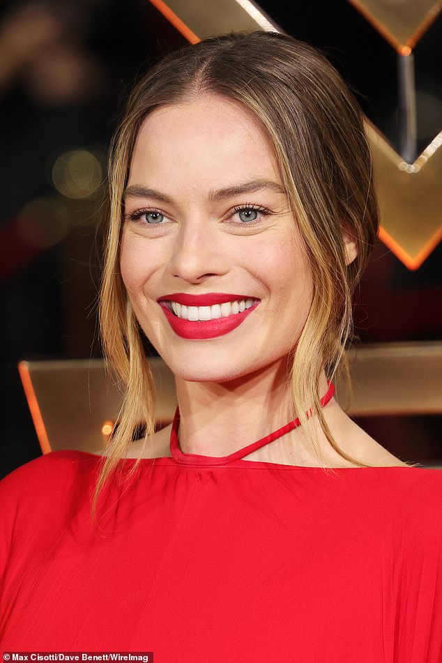 Brilliant: Matching her makeup to the ensemble, she added a bold red lip to her gently enhanced complexion