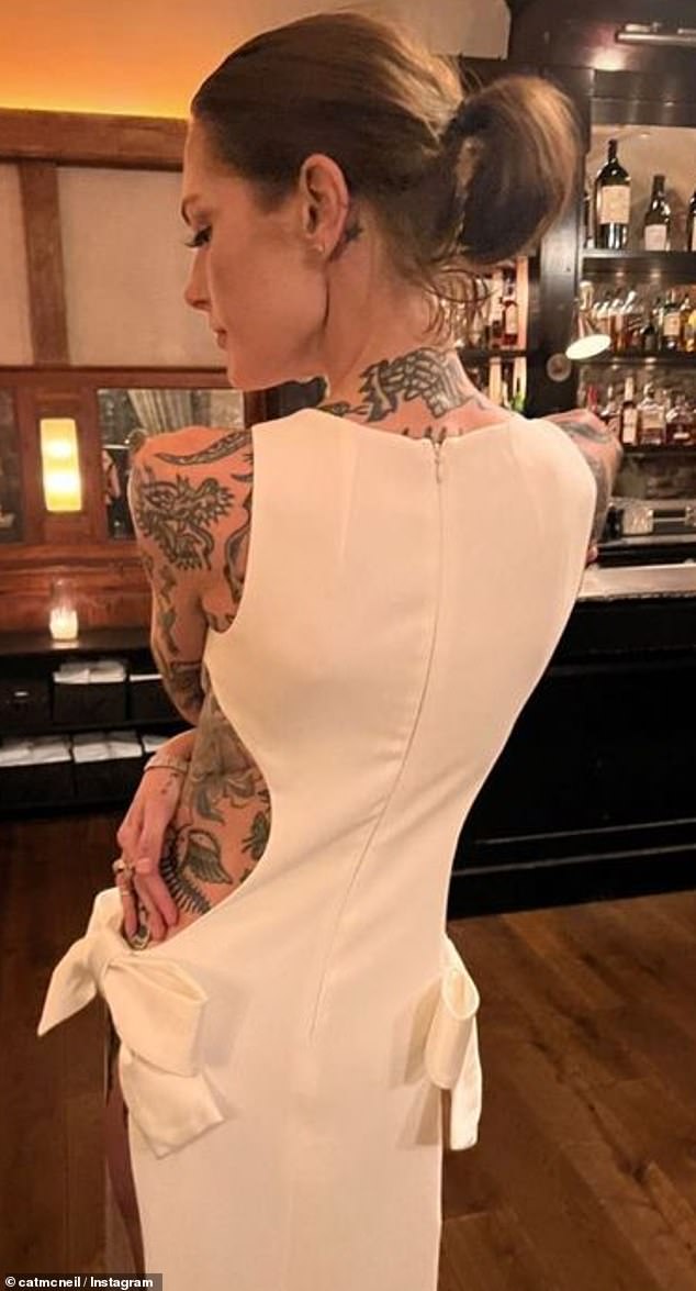 Cat also posted a rear shot of her unique dress as the couple enjoyed a casual reception at a New York bar.