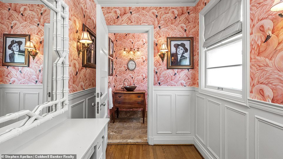 The property has 11 bathrooms, three of which are considered half baths.  In the photo, one of them with jazzy flamenco wallpaper