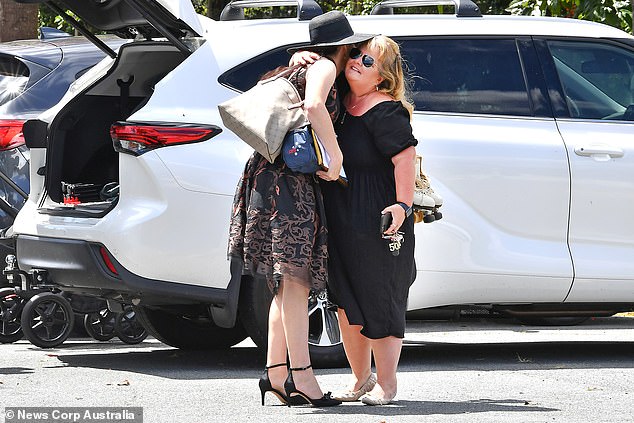 Daughter Claudine Snow holds her mother's roller skates in tribute to the sport she loved