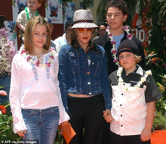 Family: The marriage resulted in two children, daughter Riley Keough (L) and son Benjamin (R);  Lisa seen in 2002 with her half-brother Navarone Garibaldi (back right)