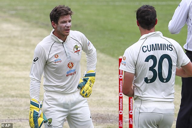 Australia's Tim Paine, left, talks to bowler Pat Cummins during the game on day three of the fourth Test cricket between India and Australia at the Gabba.