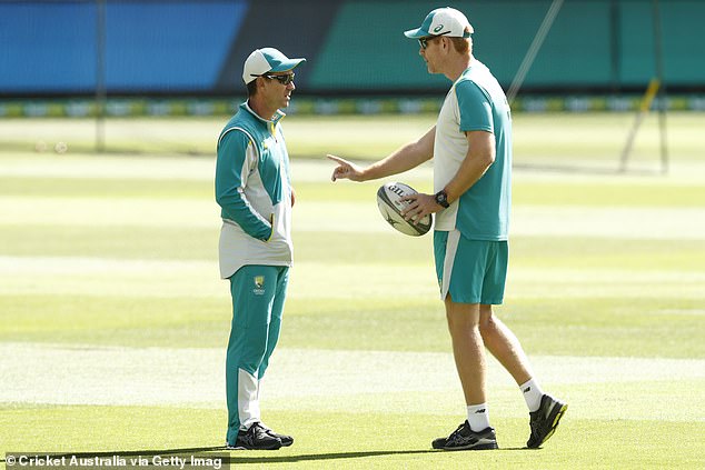 Former Australian head coach Justin Langer talks to former assistant coach Andrew McDonald before day four of the second test match between Australia and India