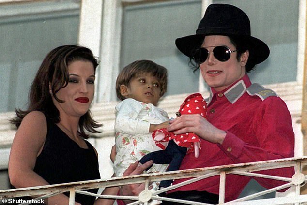 Lisa Marie Presley and Michael Jackson hold a baby during a trip to Budapest in 1994