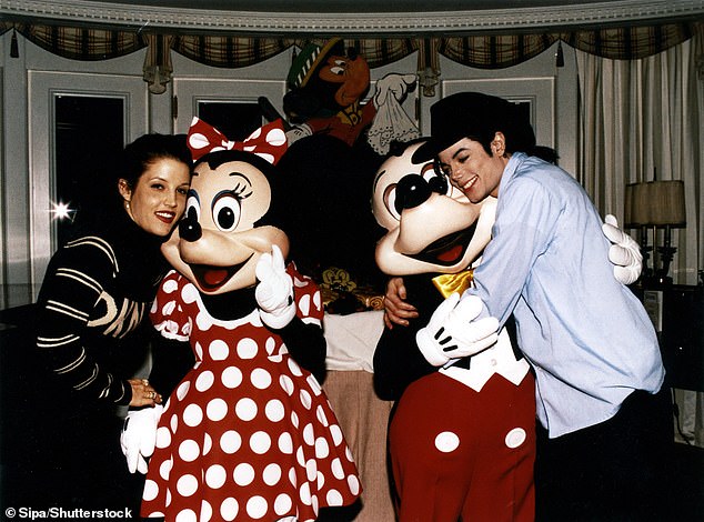 Lisa Marie Presley and Michael Jackson hug Mickey and Minnie Mouse in 1994