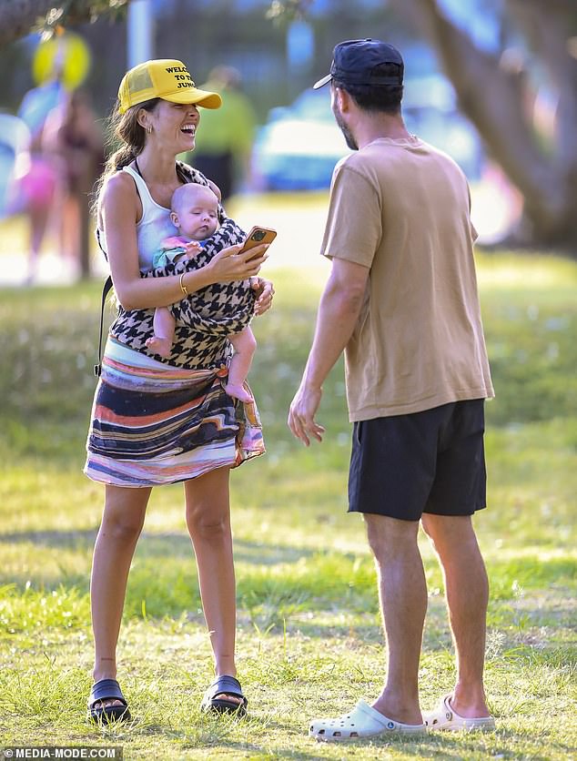 The lovebirds shared a joke while Ruby took photos of her children.