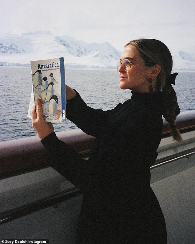 Soaking it in: The Politician star read about Antarctica while sailing a ship through the frigid waters