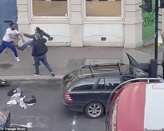 The passenger attempts to dramatically kick the pedestrian, while the driver of the Mercedes tries to defuse the situation.