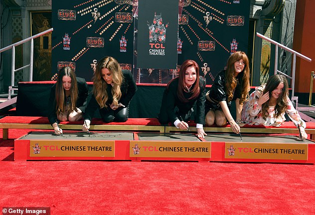 (LR Finley, Lisa Marie, Priscilla, Riley, and Harper) sign their names along with their handprints in June 2022