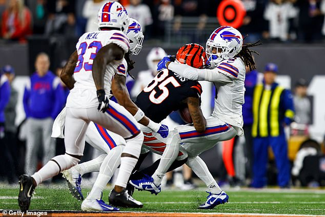 Damar Hamlin #3 of the Buffalo Bills tackles Tee Higgins #85 of the Cincinnati Bengals during the first quarter of an NFL football game at Paycor Stadium on January 2.  He would go into cardiac arrest on the play, but has since been released from the hospital.