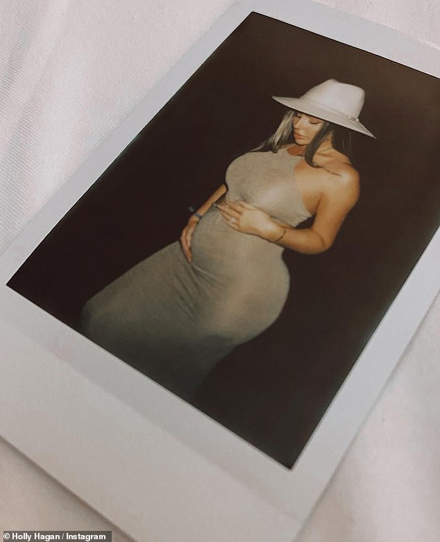 Glowing: Earlier this month, she posed for her first pregnancy photo, looking every inch the glowing mom-to-be in a gold, form-fitting, halter-neck dress