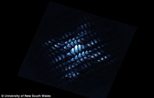 A scanning tunneling microscope shows a quantum bit from a phosphorus atom precisely positioned in silicon. Scientists have discovered how to make the qubits 'talk to one another