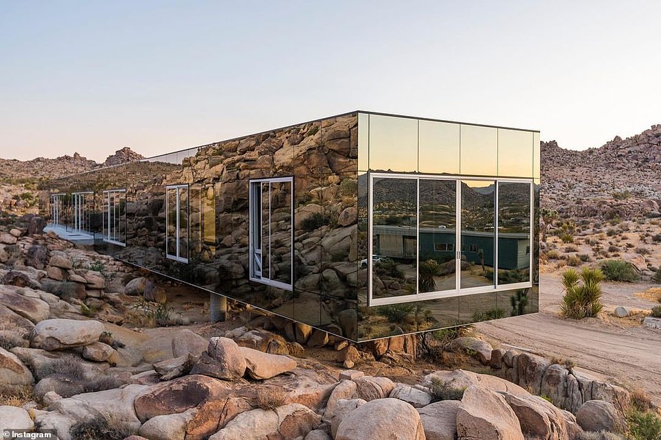 An exterior view of the cantilevered part of the house, which is supported by metal beams built into the desert rock