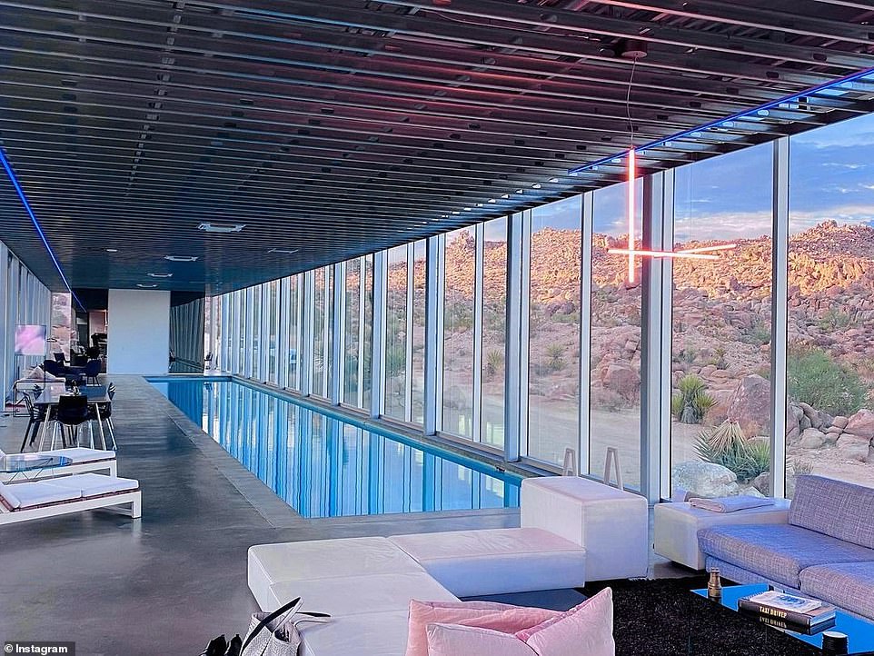 It has, among other things, a 100-foot long pool in the middle of the house.  Glass walls on three sides of the house can be opened to the outside, turning the pool into a hybrid indoor-outdoor space.