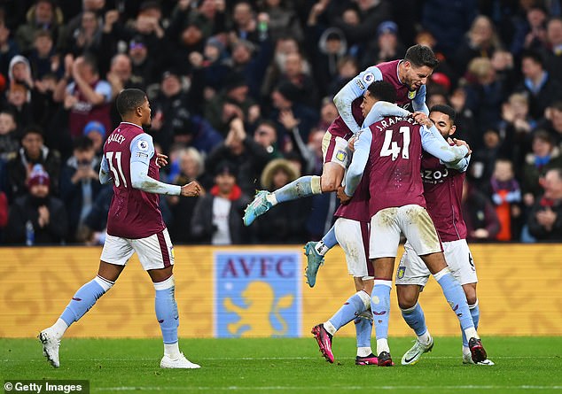 Aston Villa players celebrate doubling their second half lead against Leeds