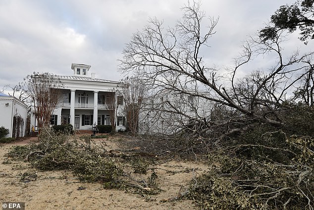 Debris and fallen trees litter the grounds outside Sturdivant Hall in Selma, Alabama