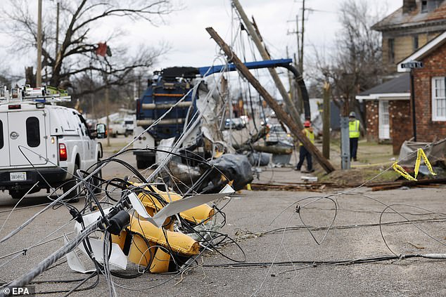 Traffic lights and power lines lie on the road after a tornado outbreak in Selma