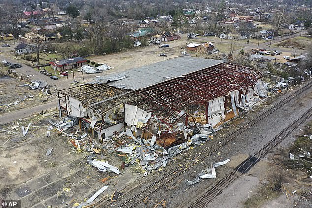 A factory roof is cut off and debris is scattered in Selma Friday, following tornadoes on Thursday.