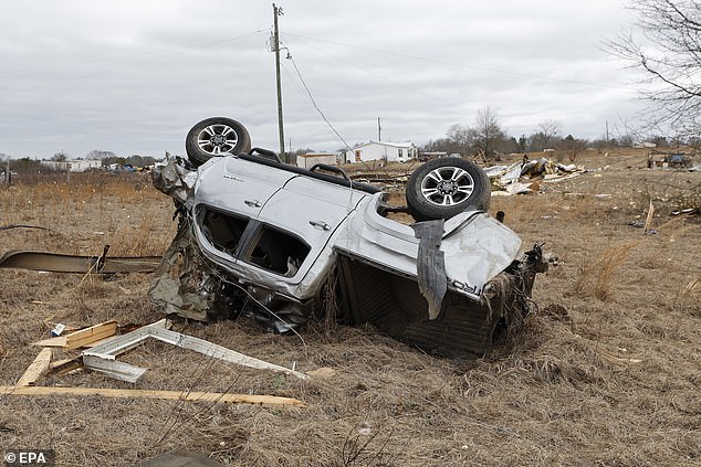 A car overturned by winds is seen in Pratville, Alabama, on Friday after the previous night's storms.