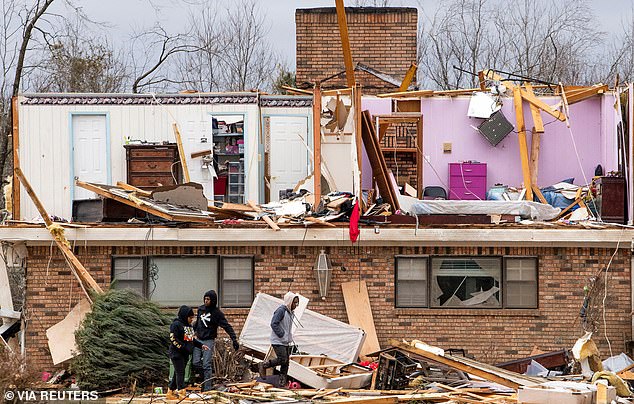 The top half of a home is seen completely exposed in Selma as people survey the damage Friday.