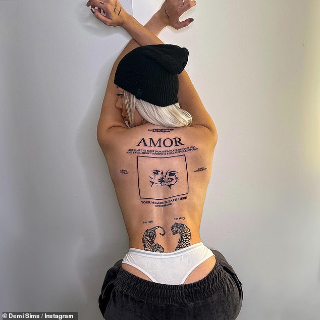 Filler: It comes after the Sims' younger sister added another back tattoo in October, going topless while showing off the huge permanent mark.
