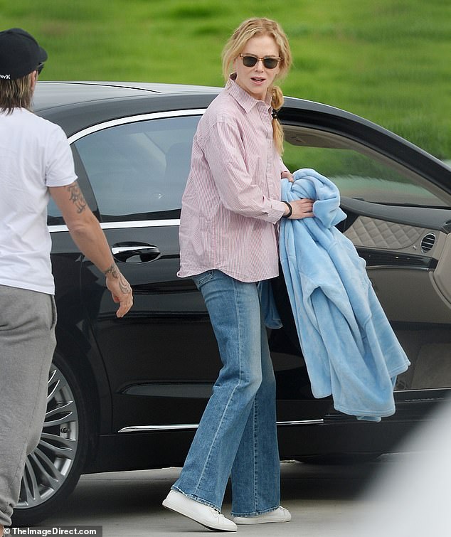 Comfort in style: The award-winning star opted for comfort for her travel day, donning a pair of classic jeans paired with a pink button-down blouse