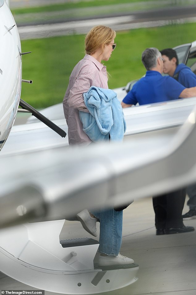 Family trip: The couple, along with their daughters, Sunday, 14, and Faith, 12, were seen earlier boarding the private jet together in Australia