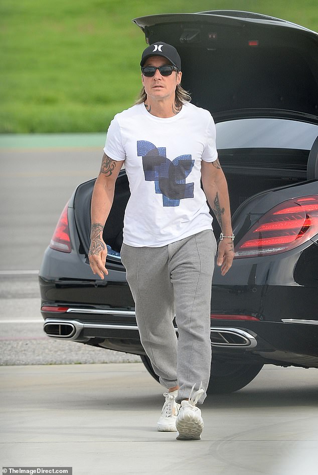 Keeping it casual: She was joined by her husband and musician, Keith Urban, who also dressed for the busy day, wearing a pair of gray sweatpants and a graphic T-shirt.