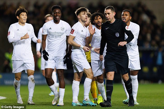 Arsenal players surrounded referee David Coote after a decision went wrong against the League One side