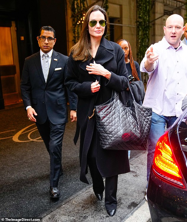 Hotel checkout: The duo were seen leaving their hotel earlier in the day, with the First They Killed My Father director carrying the same large padded YSL bag she took with her through security.