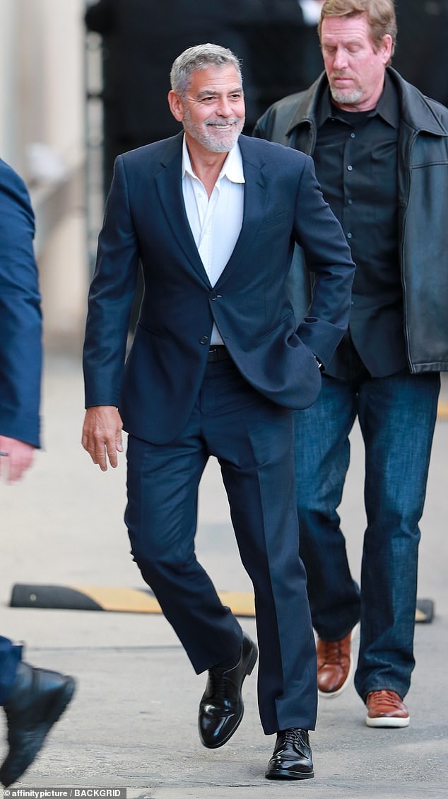 Sleek Suit: To mark his return, Clooney rocked a sleek navy suit that was impeccably tailored to fit his 5-foot-11 physique.