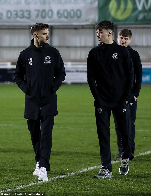 Staying warm: Romeo styled his friends in black Umbro jackets with the embroidered Brentford football team logo, with matching pants.